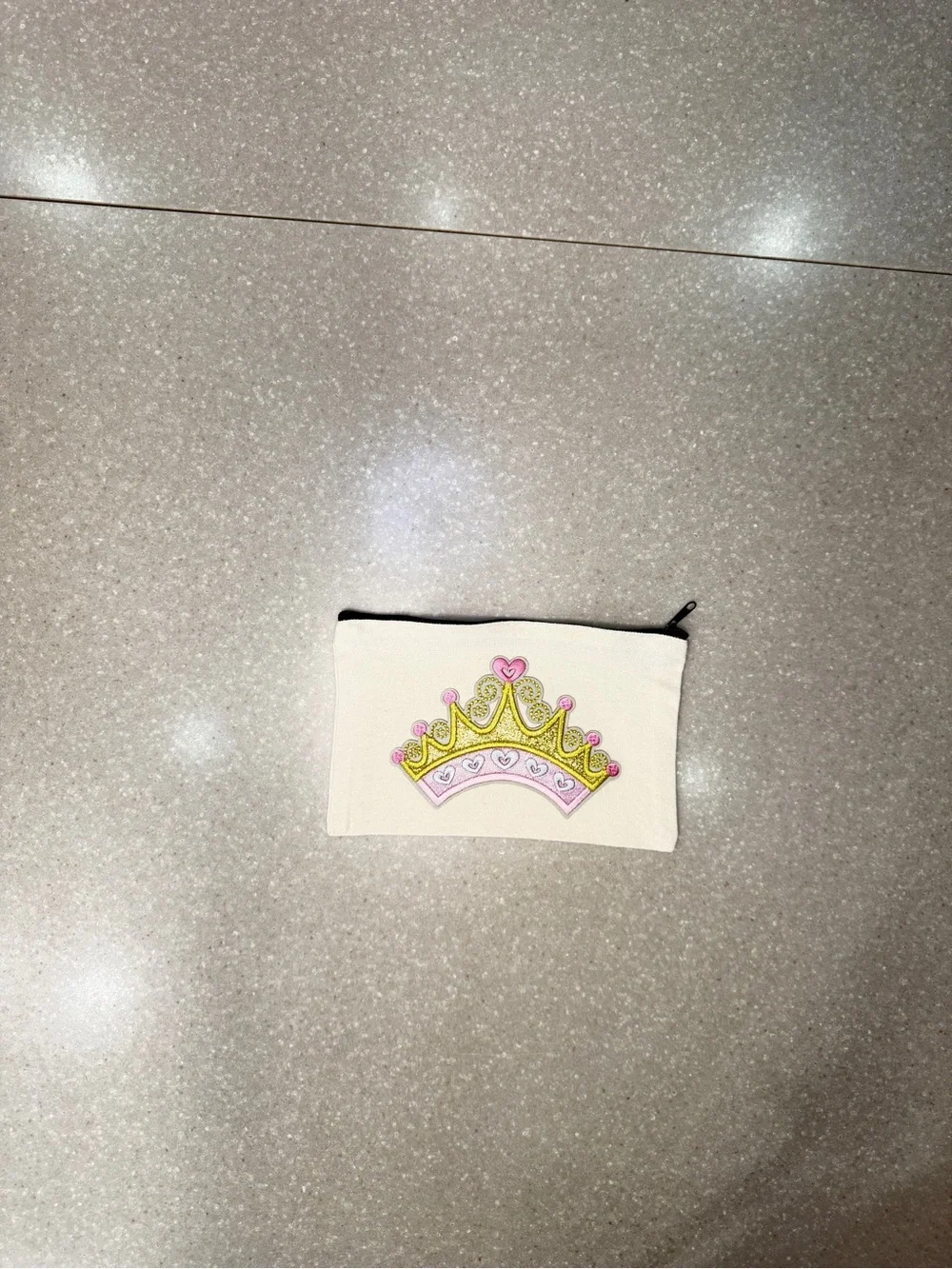 Cosmetic bag with pink crown.  Design is on both sides.